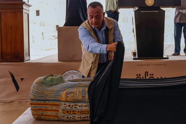Mostafa Waziri, head of Egypt's Supreme Council of Antiquities, unveils a sarcophagus in the Saqqara necropolis, wher<em></em>e archaeologists unearthed two human and animal embalming workshops as well as two tombs, south of Cairo on May 27, 2023. — AFP pic